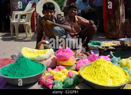 India Uttar Pradesh State in Mathura city children are selling coloured powder during Holi festival celebrations Stock Photo