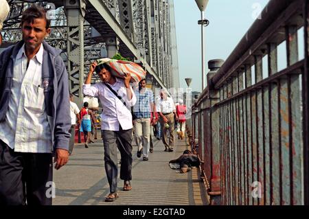 India West Bengal state Kolkota people carrying goods towards Howrah Station Stock Photo