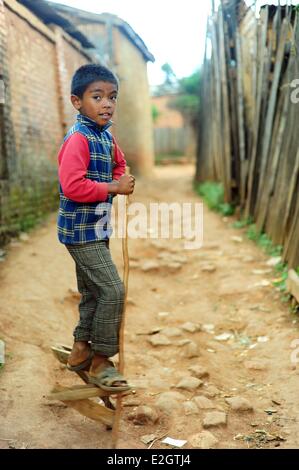 Madagascar Central Highlands Antsirabe boy walking on wooden stilts Stock Photo