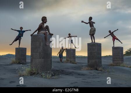 Papua New Guinea Bismarck Archipelago Gazelle peninsula New Britain island East New Britain province Rabaul kids playing in ashes in front of volcano Tavurvur Stock Photo