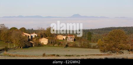 France Puy de Dome Parc naturel regional Livradois Forez (Natural regional park of Livradois Forez) landscape and Chabreyras hamlet Echandelys in background Chaine des Puys in Parc Naturel Regional des Volcans d'Auvergne (Auvergne Volcanoes Natural Park), Stock Photo