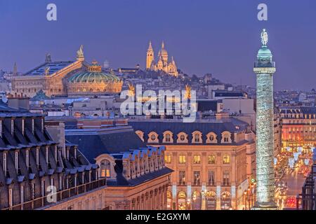 France Paris column of Place Vendomewith Napoleon's statue on top Garnier Opera house and Sacre Coeur basilica illuminated at night in background Stock Photo
