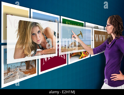 Touchscreen of the future projected in mid-air against a blue wall with drop shadows. Stock Photo