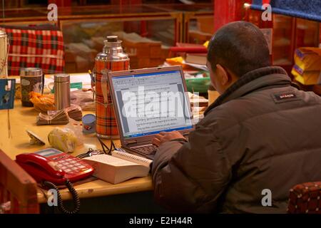 China Tibet Lhassa monk working on Buddist text on computer at Sera monastery Stock Photo