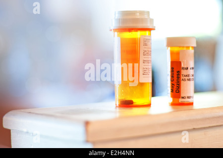 Medicine pill bottles nearly empty, needing refills soon. Stock Photo