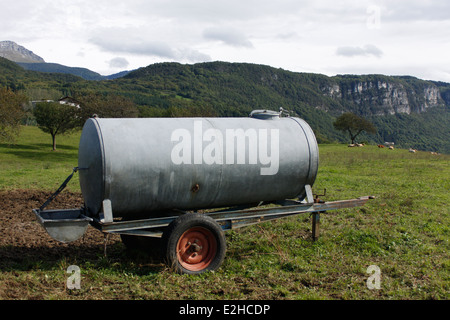 Tank for water wheel on cows in a field, Chartreuse, Isere, Rhone Alpes, France Stock Photo