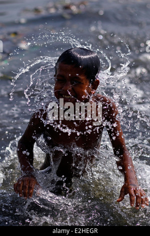 A street child swimming in polluted river burigonga,A,street,child ...