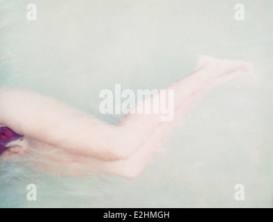 Cropped image of a muscular woman in sportswear standing with arms on hips  isolated over gray background Stock Photo - Alamy