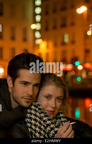 Young couple out in the city at night, portrait Stock Photo