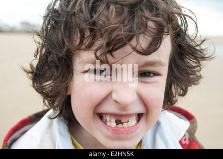 Boy showing off missing tooth, portrait Stock Photo