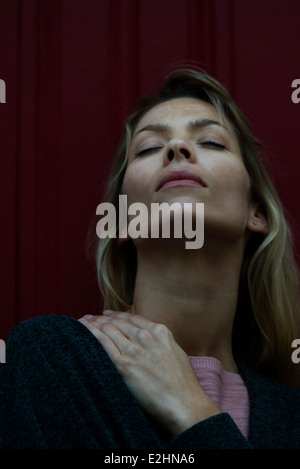 Woman rubbing sore shoulder Stock Photo