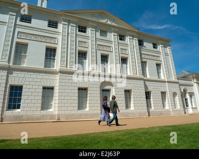 A couple walking past the  front of Kenwood House Hampstead Heath London NW3 UK  KATHY DEWITT Stock Photo