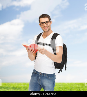 travelling student with backpack and book Stock Photo