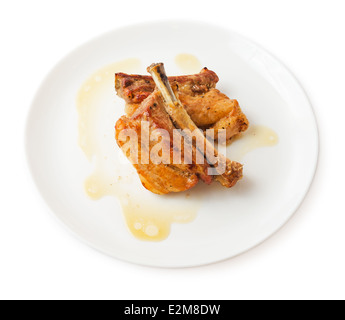 Grilled pork ribs in plate marinated in honey and soy isolated. Stock Photo