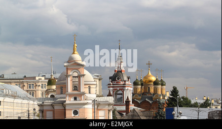 Beautiful historical churches near the Moscow Kremlin on a background cloudy sky Stock Photo