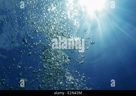Underwater bubbles rising to surface with sunlight in background, natural scene, Caribbean sea Stock Photo