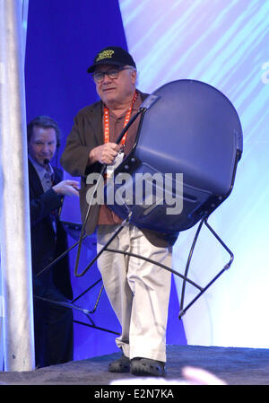 Danny Devito takes of his shoes and socks during an appearance at the Panasonic Booth at the 2013 Consumer Electronics Show  Featuring: Danny Devito Where: Las Vegas, Nevada, United States When: 09 Jan 2013 Stock Photo