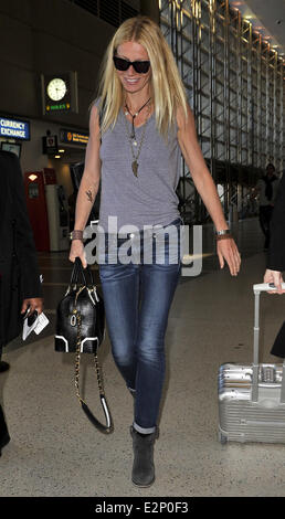 A cheerful looking Gwyneth Paltrow arrives at LAX airport sporting what resembles a temporary tattoo of an eagle on her right forearm  Featuring: Gwyneth Paltrow Where: Los Angeles, California, United States When: 19 Jan 2013 Stock Photo