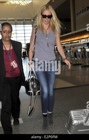 A cheerful looking Gwyneth Paltrow arrives at LAX airport sporting what resembles a temporary tattoo of an eagle on her right forearm  Featuring: Gwyneth Paltrow Where: Los Angeles, California, United States When: 19 Jan 2013 Stock Photo