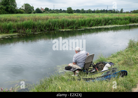 Fisherman and friend on a peaceful day by the river Cam Stock Photo