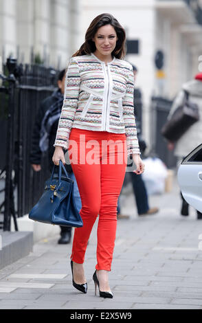 A stylish Kelly Brook seen leaving her home wearing a patterned zip-up cardigan, red skinny jeans accompanied by black heels and a Hermes hand bag  Featuring: Kelly Brook Where: London, United Kingdom When: 20 Mar 2013 Stock Photo