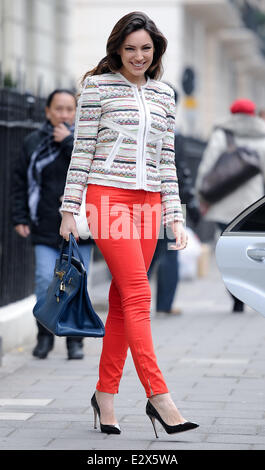 A stylish Kelly Brook seen leaving her home wearing a patterned zip-up cardigan, red skinny jeans accompanied by black heels and a Hermes hand bag  Featuring: Kelly Brook Where: London, United Kingdom When: 20 Mar 2013 Stock Photo