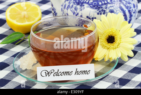 Welcome home card with cup of tea, lemon, cream gerbera daisy Stock Photo