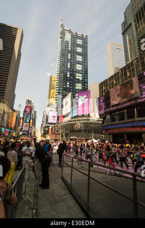 NEW YORK, NY - JUNE 21:  New Yorkers are marking the first day of summer by practicing Yoga in Times Square during the 12th annual Solstice in Times Square on June 21, 2014 in New York City.  (Photo by Donald Bowers) Stock Photo