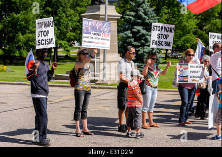 Toronto, Canada. 21st June 2014. Group of protesters during demonstration in support of citizens of Donetsk, Lugansk and Odessa regions, against aggression of Ukrainian army towards civilians, at Ontario Legislature building in Downtown Toronto. Eastern regions fought for independence from the nationalistic opposition that came to power in Ukraine in early 2014. Present country officials used full military resources against the rebellions, which resulted in a number of casualties among civilians. Credit:  Igor Ilyutkin/Alamy Live News Stock Photo