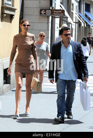 Bianca Balti smokes a cigarette whilst walking along Via Montenapoleone with a male companion  Featuring: Bianca Balti Where: Milan, Italy When: 09 May 2013  **Not available for publication in Italy** Stock Photo