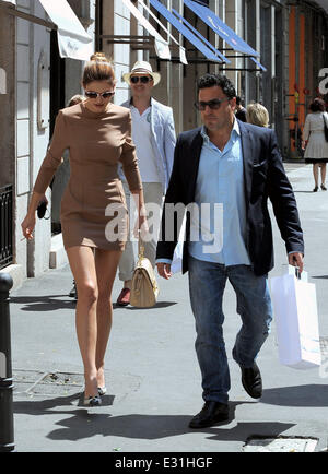 Bianca Balti smokes a cigarette whilst walking along Via Montenapoleone with a male companion  Featuring: Bianca Balti Where: Milan, Italy When: 09 May 2013 Stock Photo