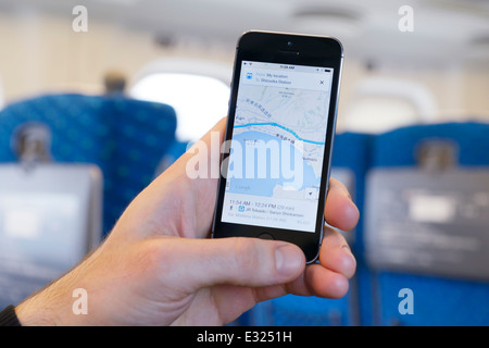 License available at MaximImages.com Person using iPhone Google maps GPS app while traveling on a Shinkansen train in Japan Stock Photo