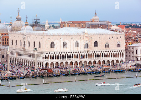 View from cruise ship departing Venice along the Giudecca Canal passing Doges Palace and row of moored gondolas along the Molo Stock Photo