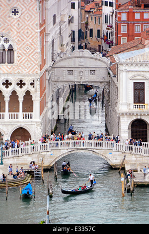 View from cruise ship departs Venice along Giudecca Canal passing busy Bridge of Sighs at junction Rio di Palazzo canal Venetian Lagoon Veneto Italy