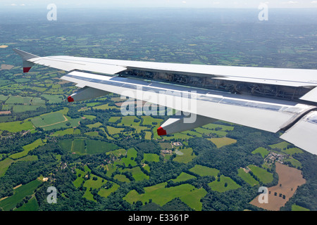 Close up of aircraft wing controls being operated to help control the flying of a civilian passenger jet Stock Photo