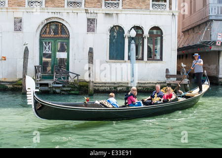 Ancient gondolas boat in Venice. Gondolier on black gondola Stock Photo