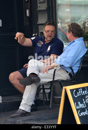 Russell Crowe smokes a cigarette while having a conversation with a friend in Tribeca  Featuring: Russell Crowe Where: New York City, NY, United States When: 09 Jun 2013 Stock Photo