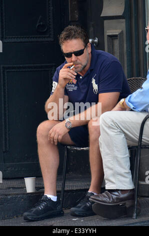 Russell Crowe smokes a cigarette while having a conversation with a friend in Tribeca  Featuring: Russell Crowe Where: New York Stock Photo