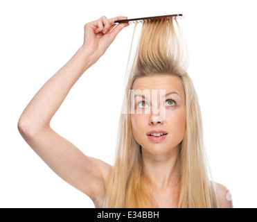 Young woman combing hair Stock Photo