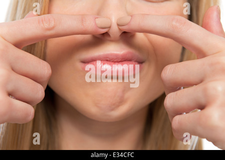 Closeup on teenager poping pimple Stock Photo