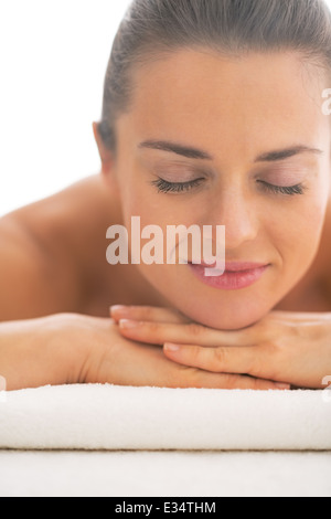 Portrait of young woman laying on massage table Stock Photo