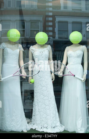 Wimbledon London, UK. 22nd June 2014. A shop  in Wimbledon  displaying models holding rackets with their heads as tennis balls Stock Photo