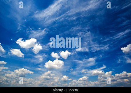 Blue daylight summer sky with fluffy white clouds as nature background. Stock Photo