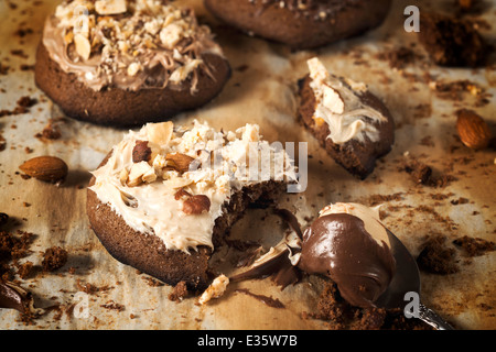 Selective focus on the front cookie with melted white chocolate and nuts Stock Photo