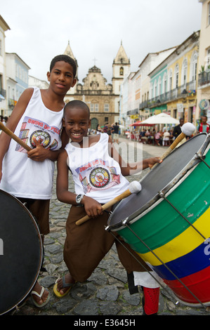 SALVADOR, BRAZIL - OCTOBER 15, 2013: Young Brazilians stand drumming in a group in the historical center of Pelourinho. Stock Photo