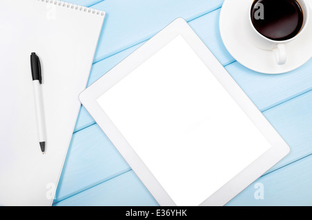 Tablet with an empty screen close to a pen and white cup Stock Photo