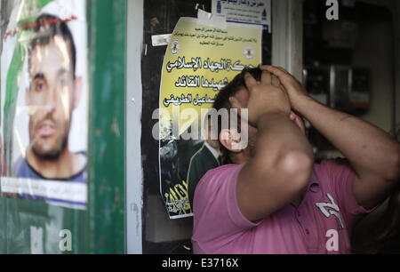 Ramallah, West Bank. 22nd June, 2014. A relative mourns at the funeral of Mahmoud Ismail in the West Bank city of Ramallah, June 22, 2014. The medical sources confirmed that Mahmoud Ismail, 36 years old, was shot dead by Israeli soldiers during clashes in the city. The large-scale Israeli military operation in the West Bank to search three missing teenagers continues as the Palestinians decided on Sunday to approach the UN Security council to put an end to the offensive.  Credit: Fadi Arouri/Xinhua/Alamy Live News Stock Photo
