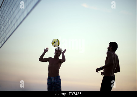 RIO DE JANEIRO, BRAZIL - FEBRUARY 11, 2014: Brazilian men on Ipanema Beach playing footvolley, a football volleyball sport. Stock Photo