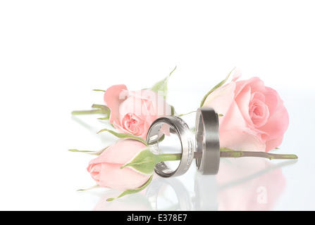 wedding rings on pillow with roses Stock Photo