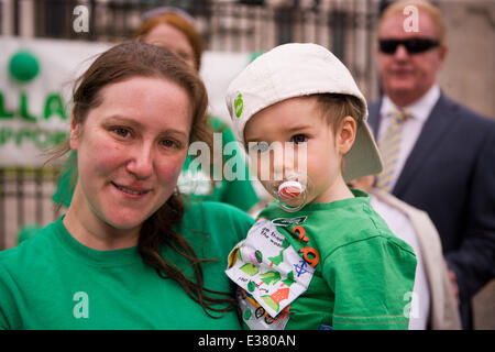 Belfast City Hall,UK. 22nd June 2014. A Macmillan Supporter with her Son Sam at the 6 Marathons in 6 Countries in 6 Days finish line in Belfast Stock Photo